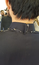 Alteration done one balck dress with saftey pins